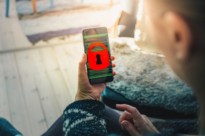 Woman holding smart phone device showing screen filled with binary code and a red padlock; Shutterstock ID 1109269646; Brand: Dark Reading; Event location or product (e.g. mag, webinar): Mag; Event / Publication Date (mm/yy): July 3; Purpose (Edit, Marketing, or Custom): Edit